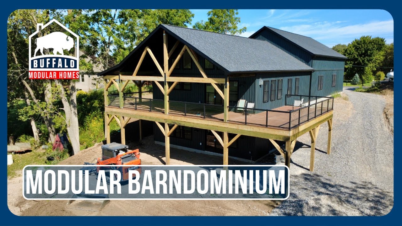 Modular barndominium with a walkout basement and a wraparound porch