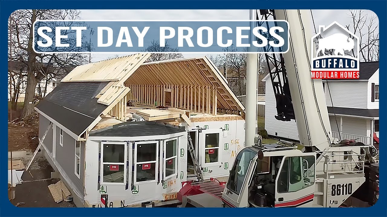 Crane setting a modular home on its foundation on a city lot in Buffalo, NY